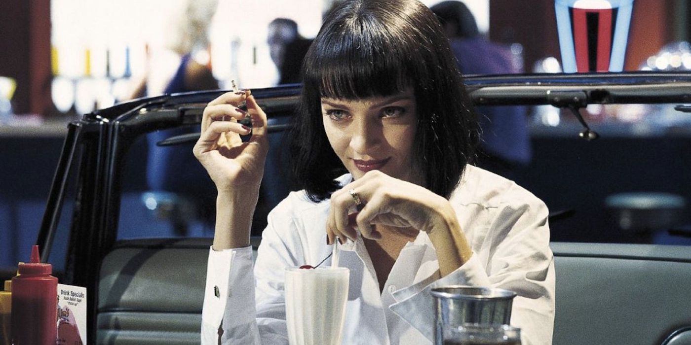 Uma Thurman as Mia Wallace drinking a milkshake and smoking in Pulp Fiction