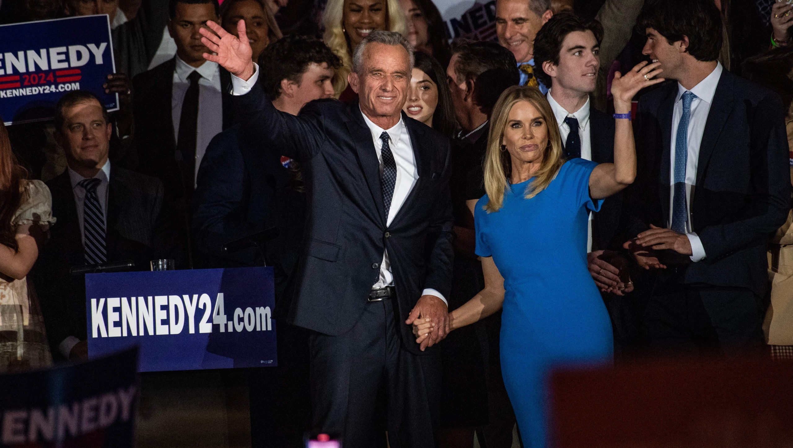 Robert F Kennedy Jr., with his wife Cheryl Hines, waves to supporters during a campaign event to launch his 2024 presidential bid, at the Boston Park Plaza in Boston, Massachusetts, on April 19, 2023. (Photo by JOSEPH PREZIOSO / AFP) (Photo by JOSEPH PREZIOSO/AFP via Getty Images)