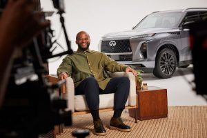 Tim Hinshaw sitting in a chair in front of an 2025 INFINITI QX80