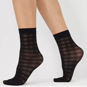 woman wears sheer socks with a grid pattern on them