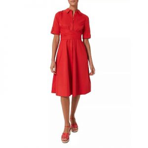 A woman wearing a red shirtdress and red sandals