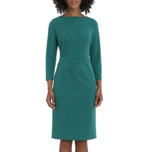 A woman wearing a green sheath dress