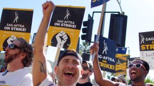 LOS ANGELES, CALIFORNIA - NOVEMBER 08: SAG-AFTRA members and supporters chant outside Paramount Studios on day 118 of their strike against the Hollywood studios on November 8, 2023 in Los Angeles, California. A tentative labor agreement has been reached between the actors union and the Alliance of Motion Picture and Television Producers (AMPTP) with the strike set to end after midnight. (Photo by Mario Tama/Getty Images)