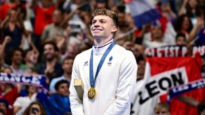 Gold medallist France's Leon Marchand poses with his medal on the podium of the men's 200m individual medley swimming event during the Paris 2024 Olympic Games at the Paris La Defense Arena in Nanterre, west of Paris, on August 2, 2024. (Photo by Manan VATSYAYANA / AFP) (Photo by MANAN VATSYAYANA/AFP via Getty Images)