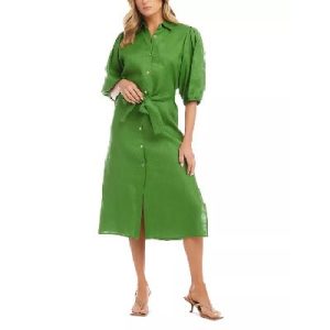 A woman wearing a green puff-sleeve dress and beige sandals