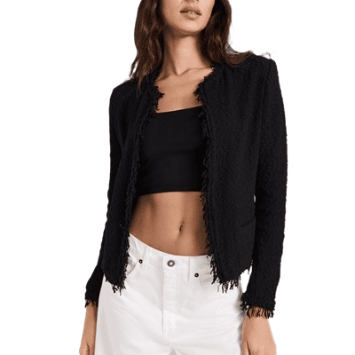 woman wears black Chanel-style lady jacket with fringed trim with a black cropped top and white jeans