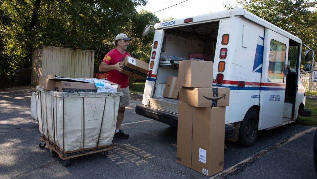 WINTERVILLE, GA - SEPTEMBER 22: Postman Robert Nagel loads packages onto a mail truck outside the post office in Winterville, Georgia.(Dustin Chambers for The Washington Post via Getty Images)