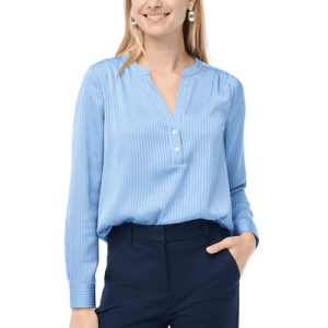 woman wears popover blouse with buttons on placket, cuffs on sleeves, and small shadow stripes