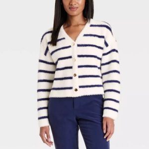 A woman wearing a white blue stripe cardigan jacket and blue pants